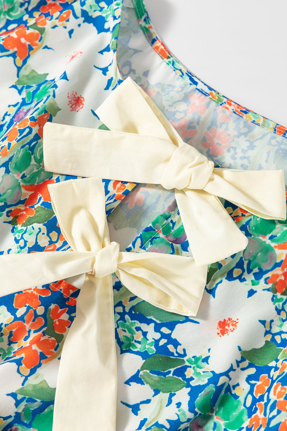 Floral Bow Tie Sleeveless Peplum Blouse